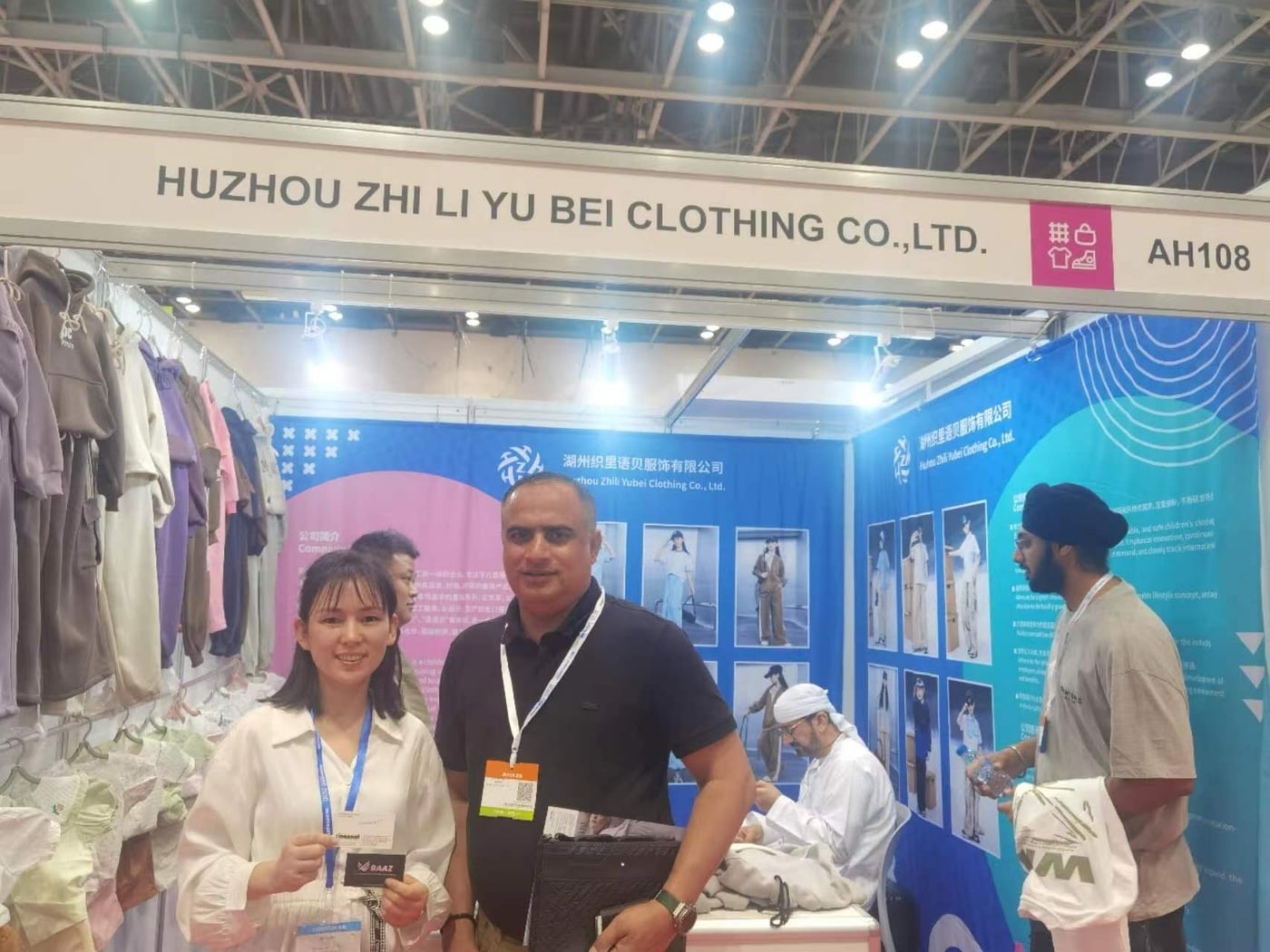 Yubei Apparel team welcoming a buyer at the Guangzhou Canton Fair booth